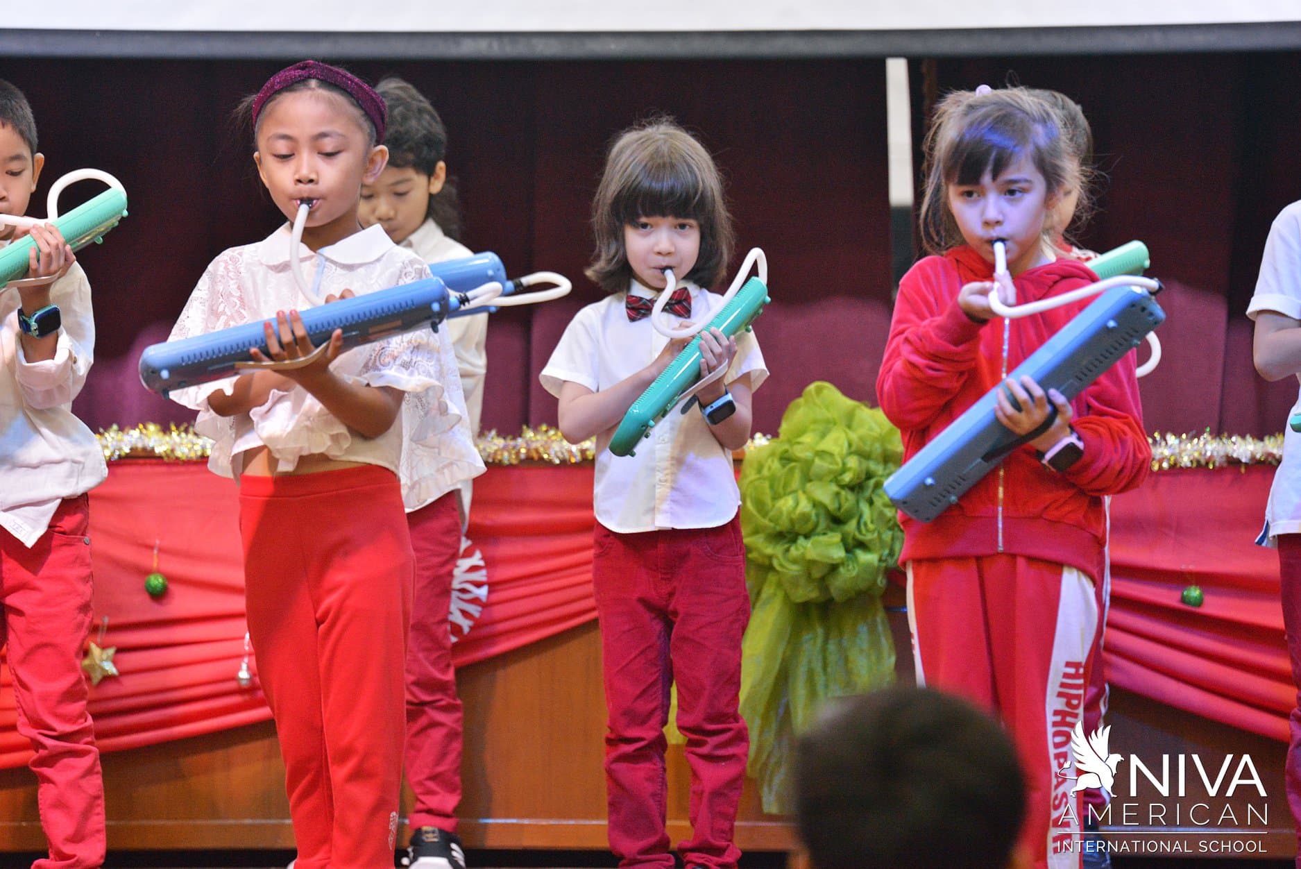 NIVA Music - Elementary students performing pianica on stage