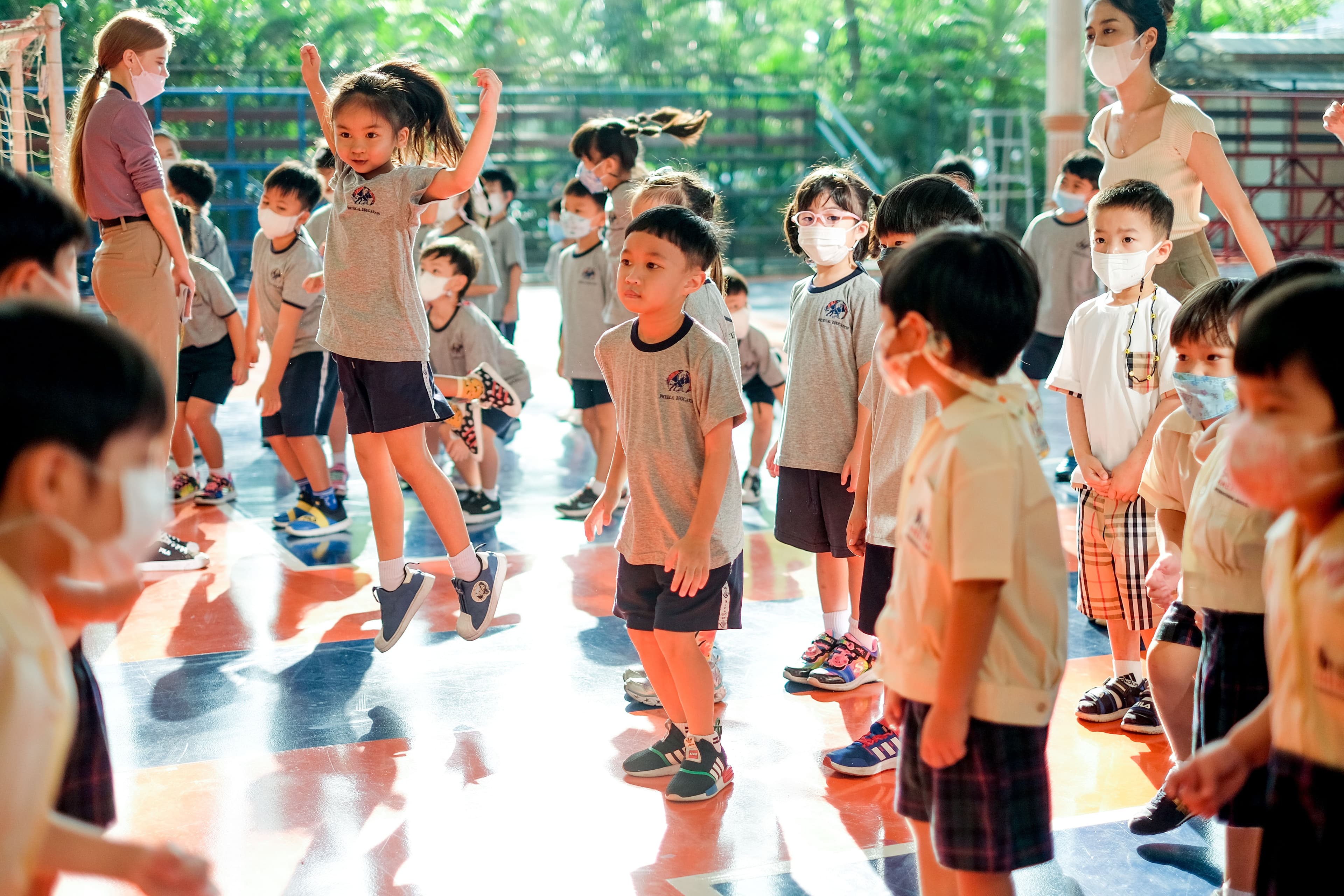 NIVA American International School kindergarten students jumping and dancing during morning exercise