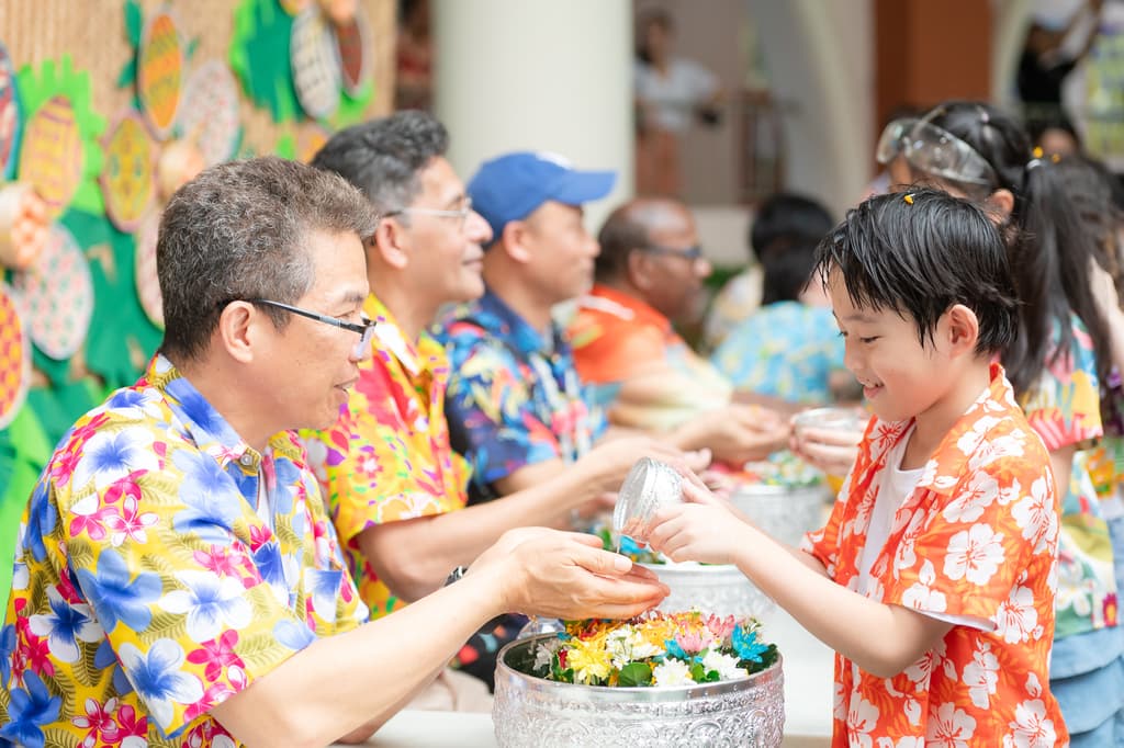 Student pouring water to Mr. Nuj