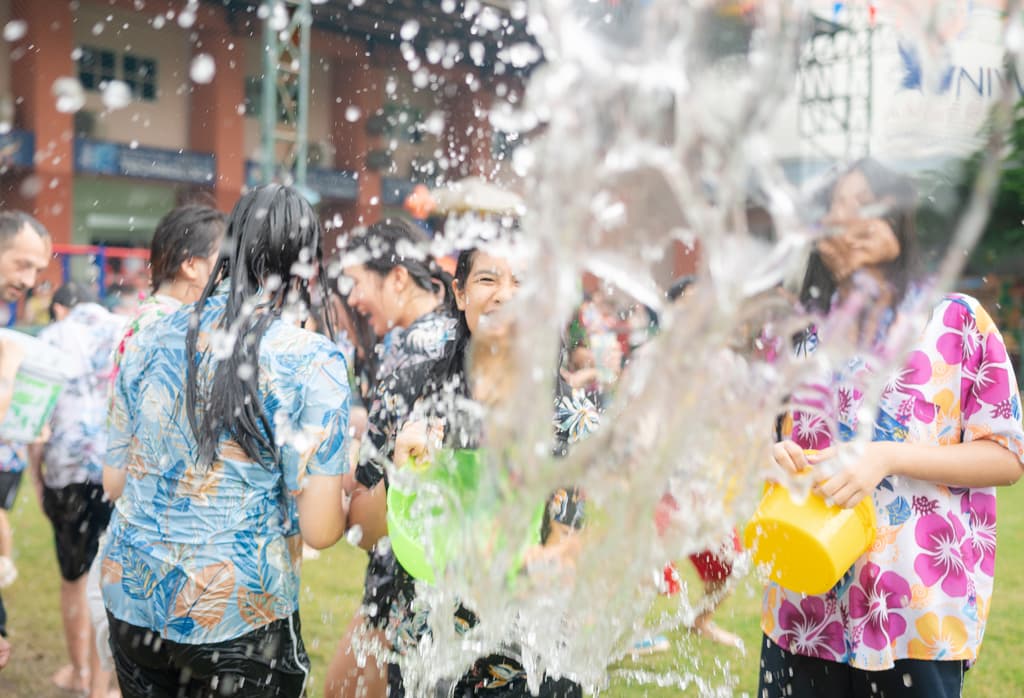 Student splashing water at camera