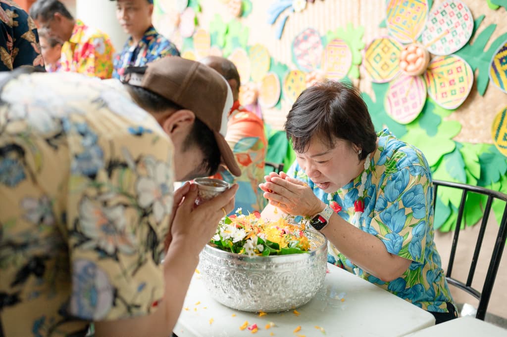 Student performing wai gesture