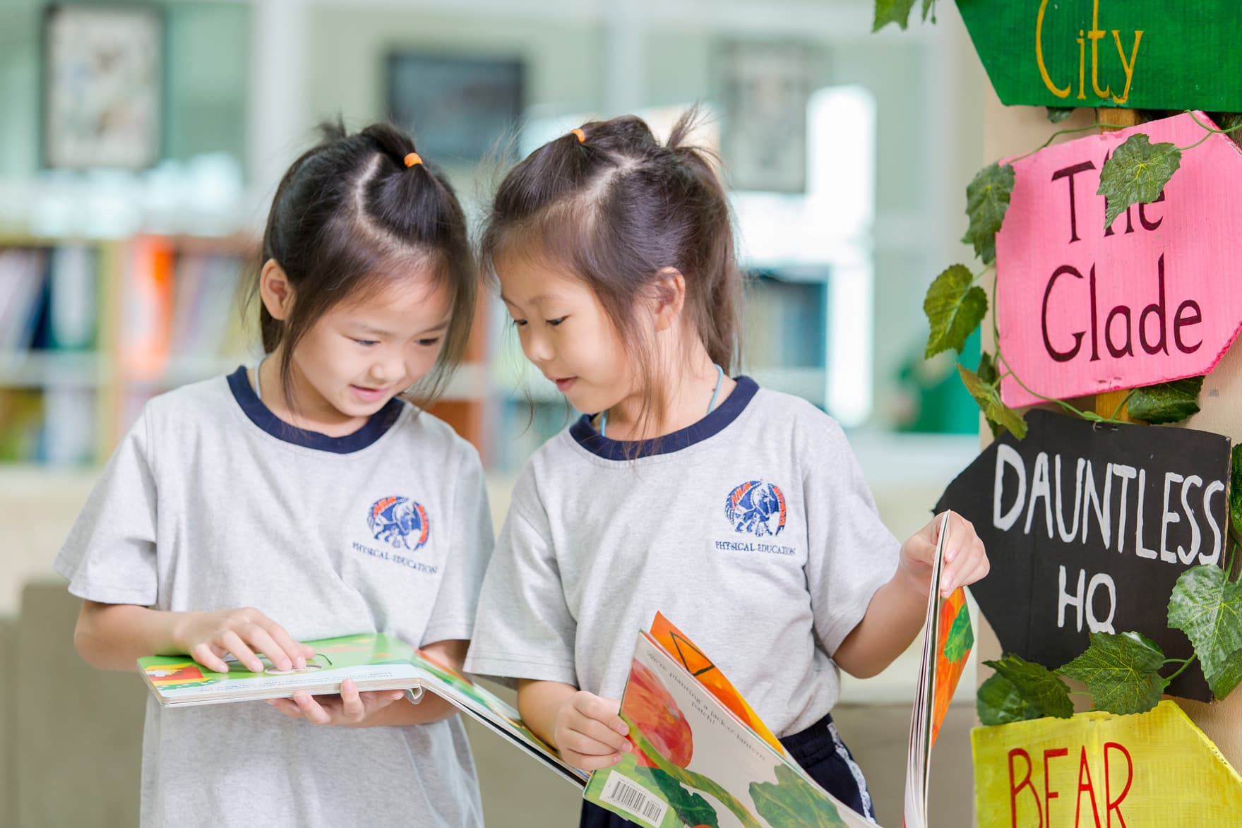 NIVA Library - Two elementary girls reading together in the library