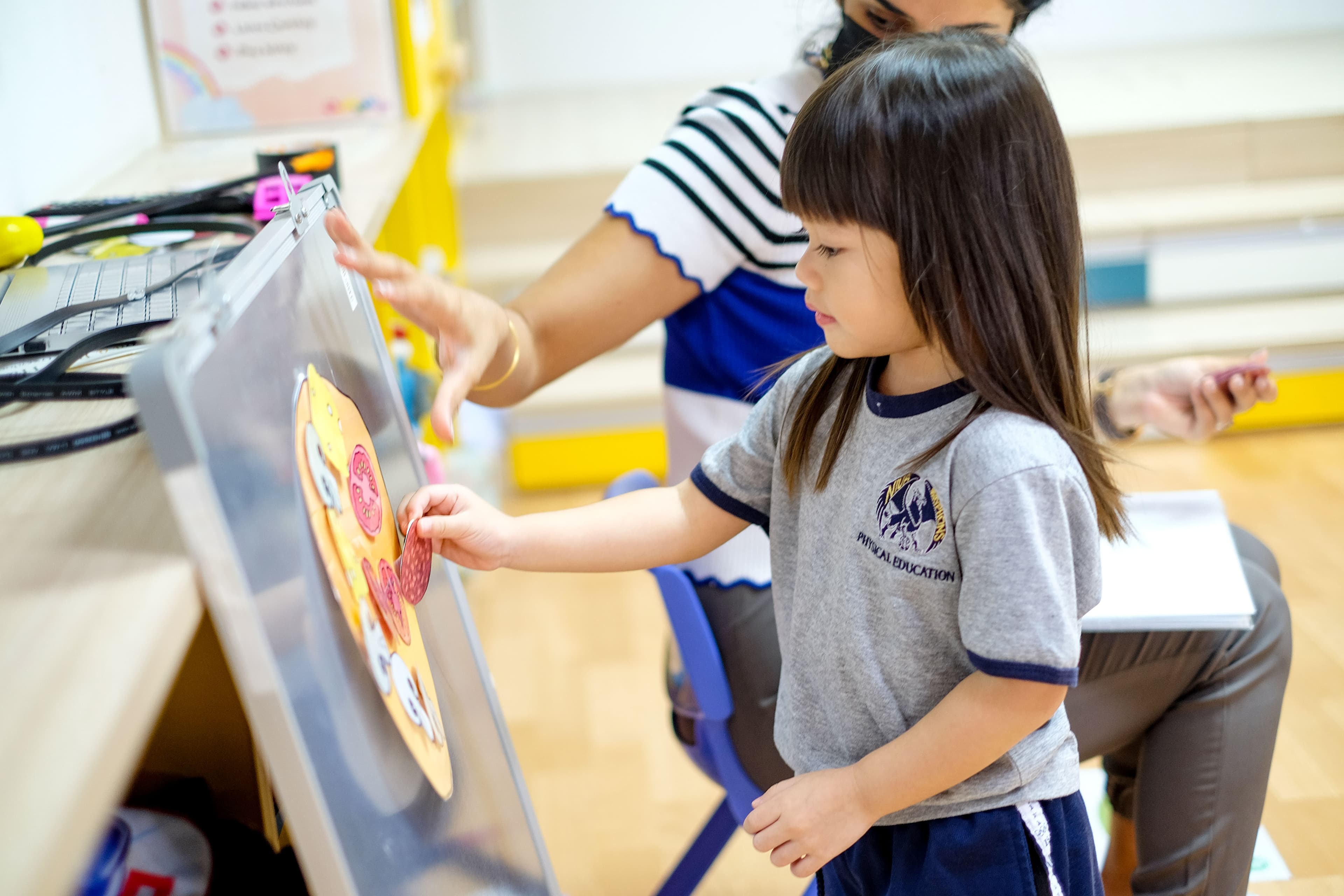 A NIVA American International School kindergarten student in art class