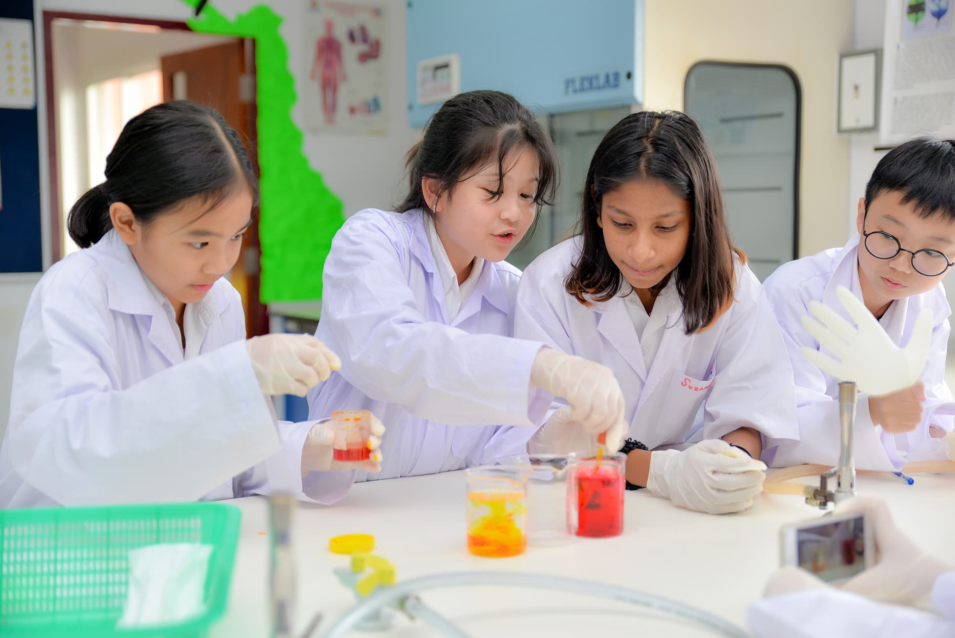 NIVA Science Laboratory - Students mixing colorful chemicals in the lab