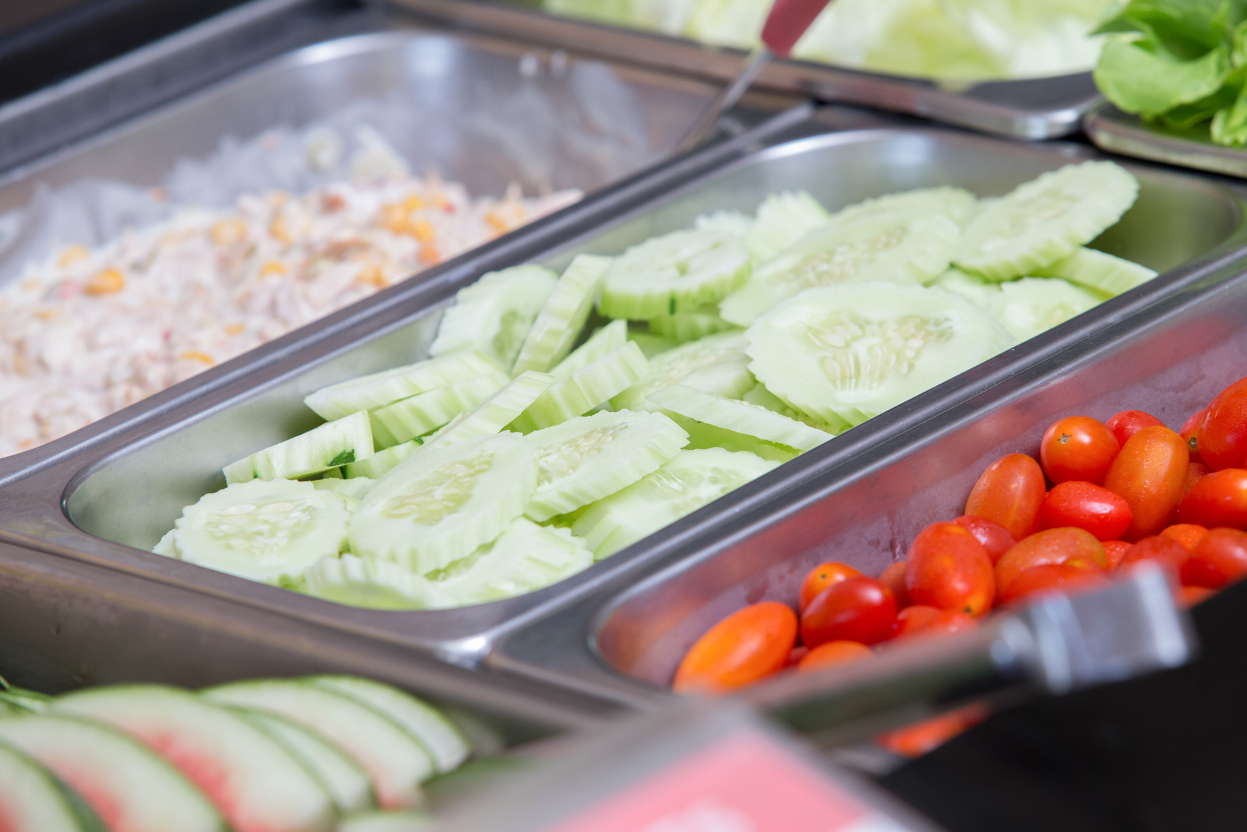 Cucumber slices and tomatoes at the canteen salad counter
