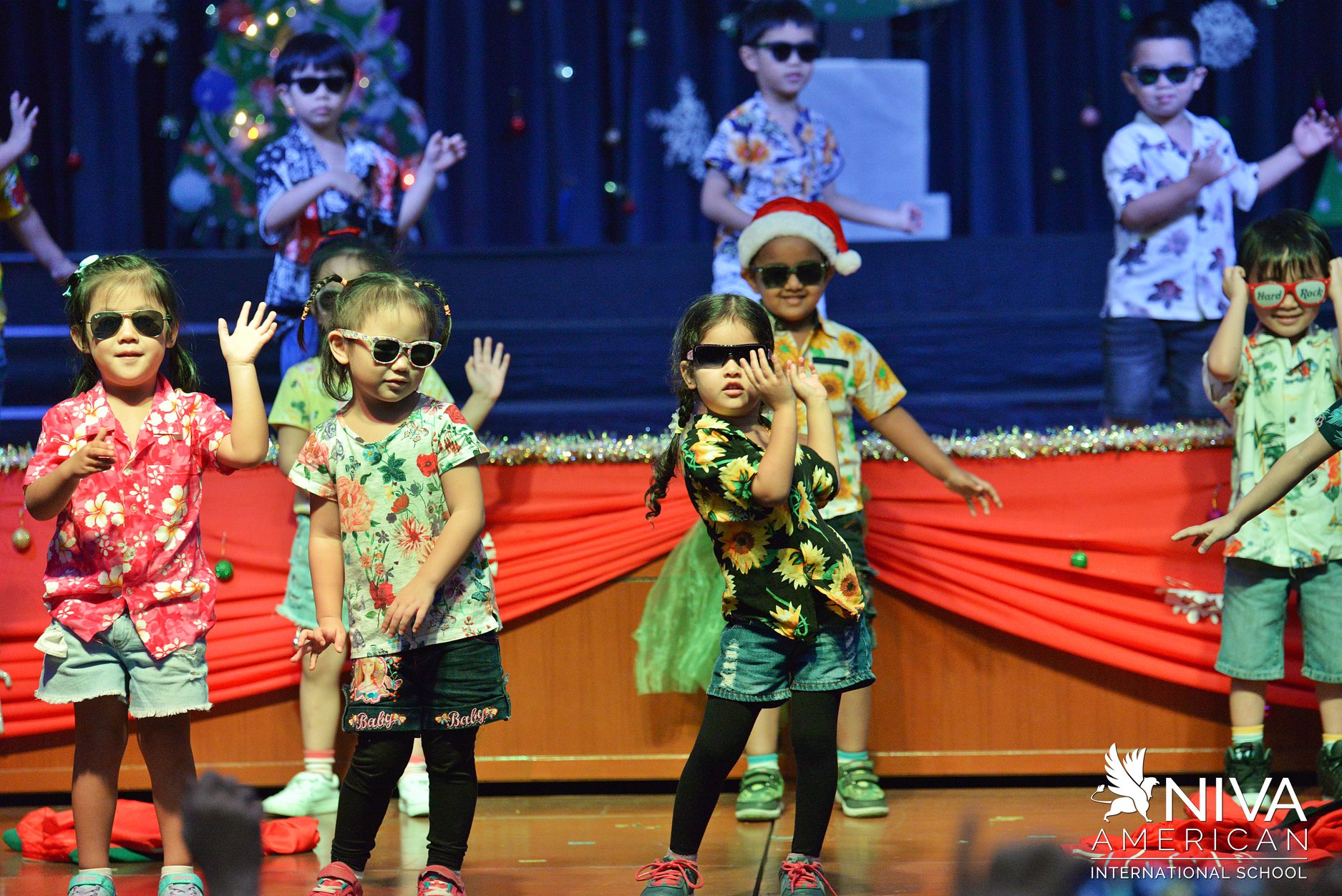 Kindergarten students dancing on stage at a Christmas celebration