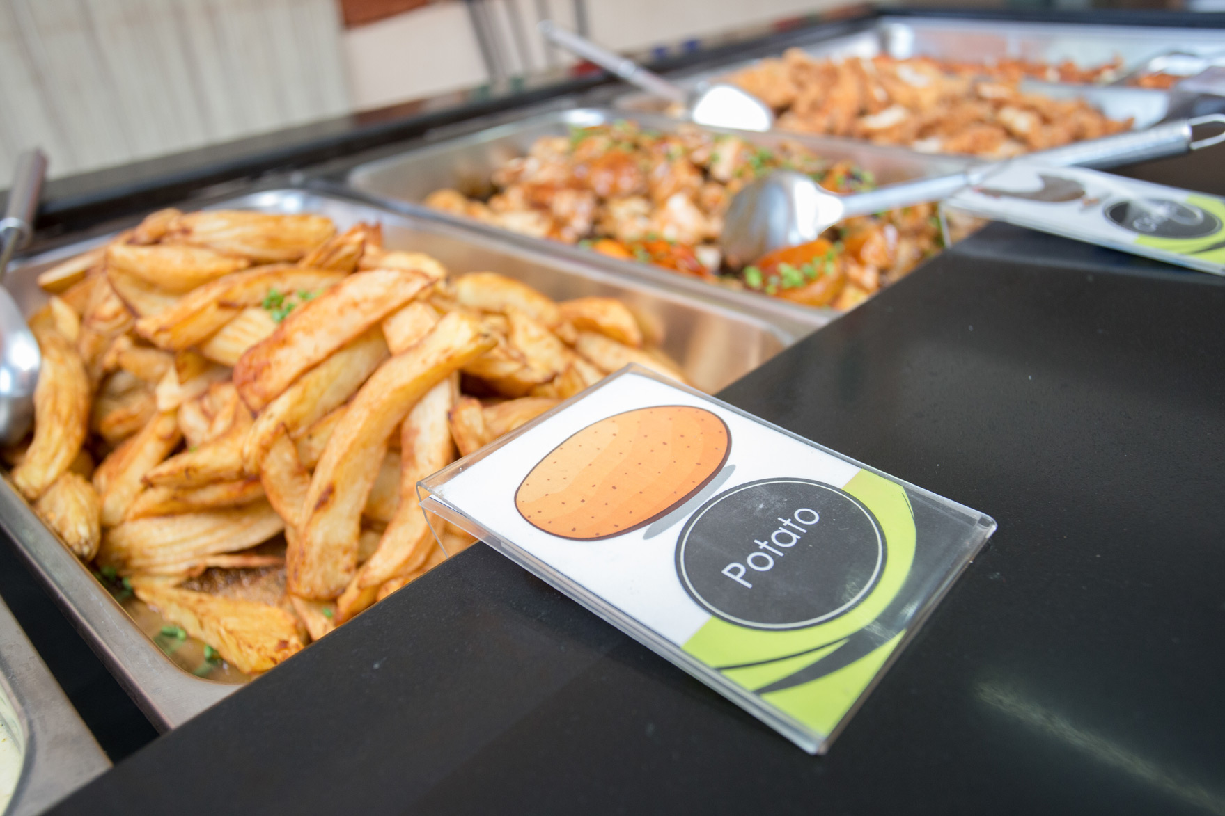 Potato wedges at the canteen serving counter
