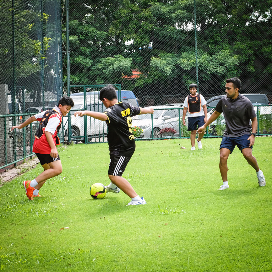 Students playing football on the school field