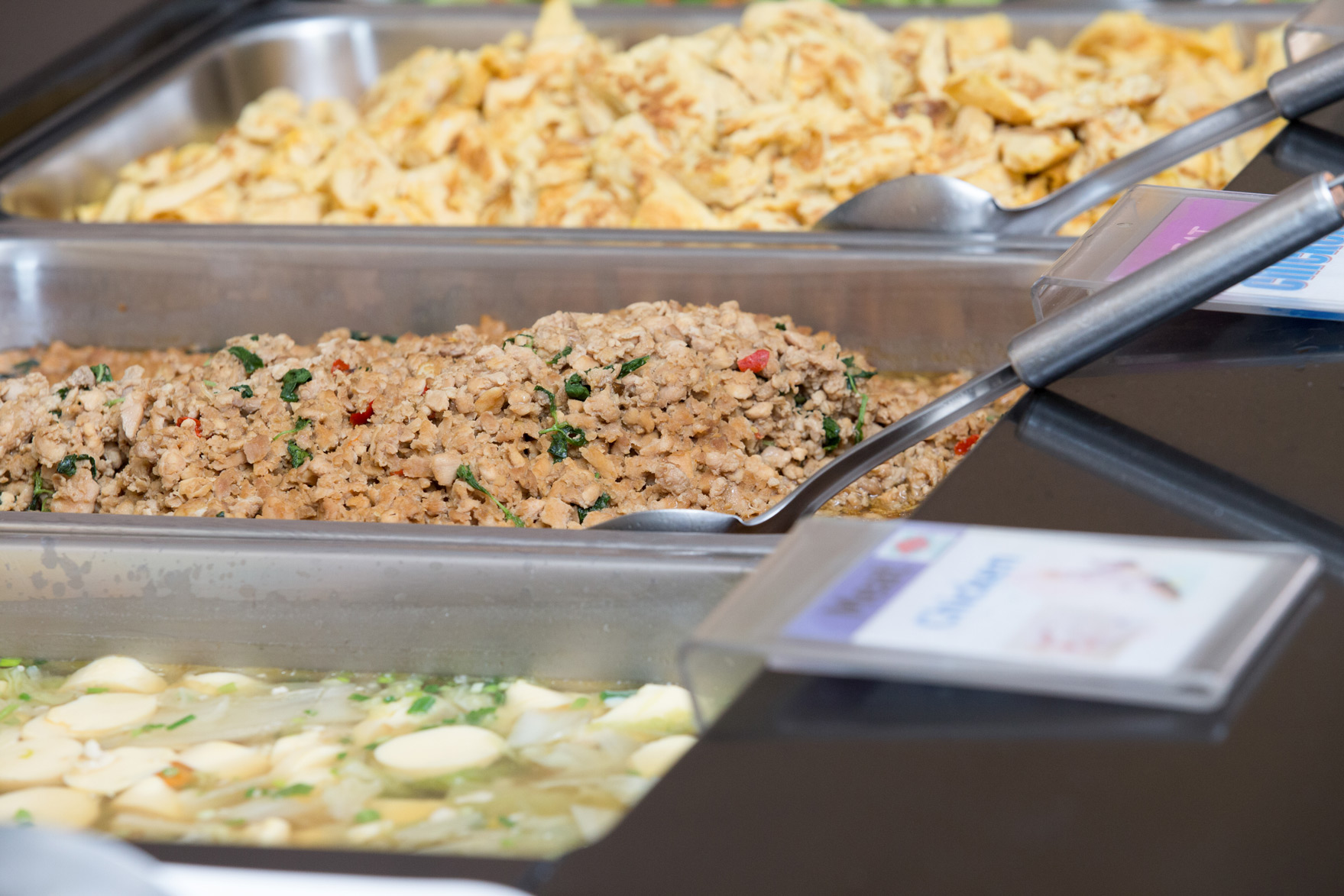 Soup and cooked dishes at the canteen serving counter