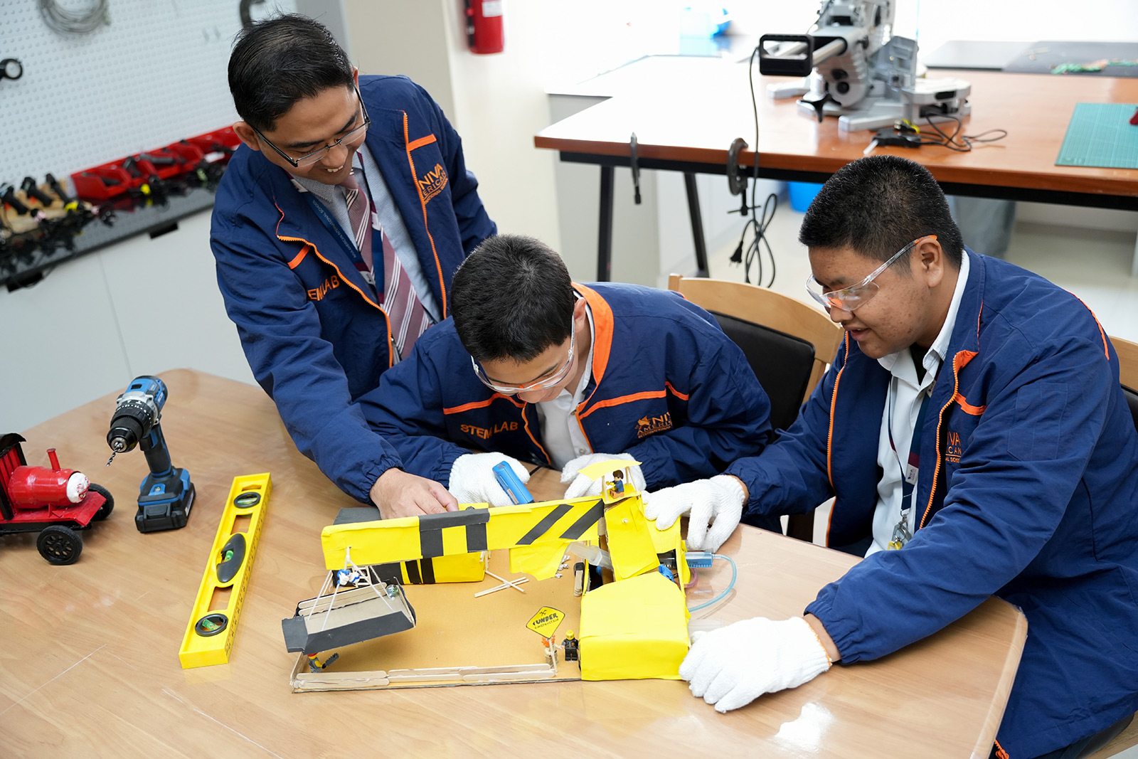Students assembling a model crane in the STEM lab