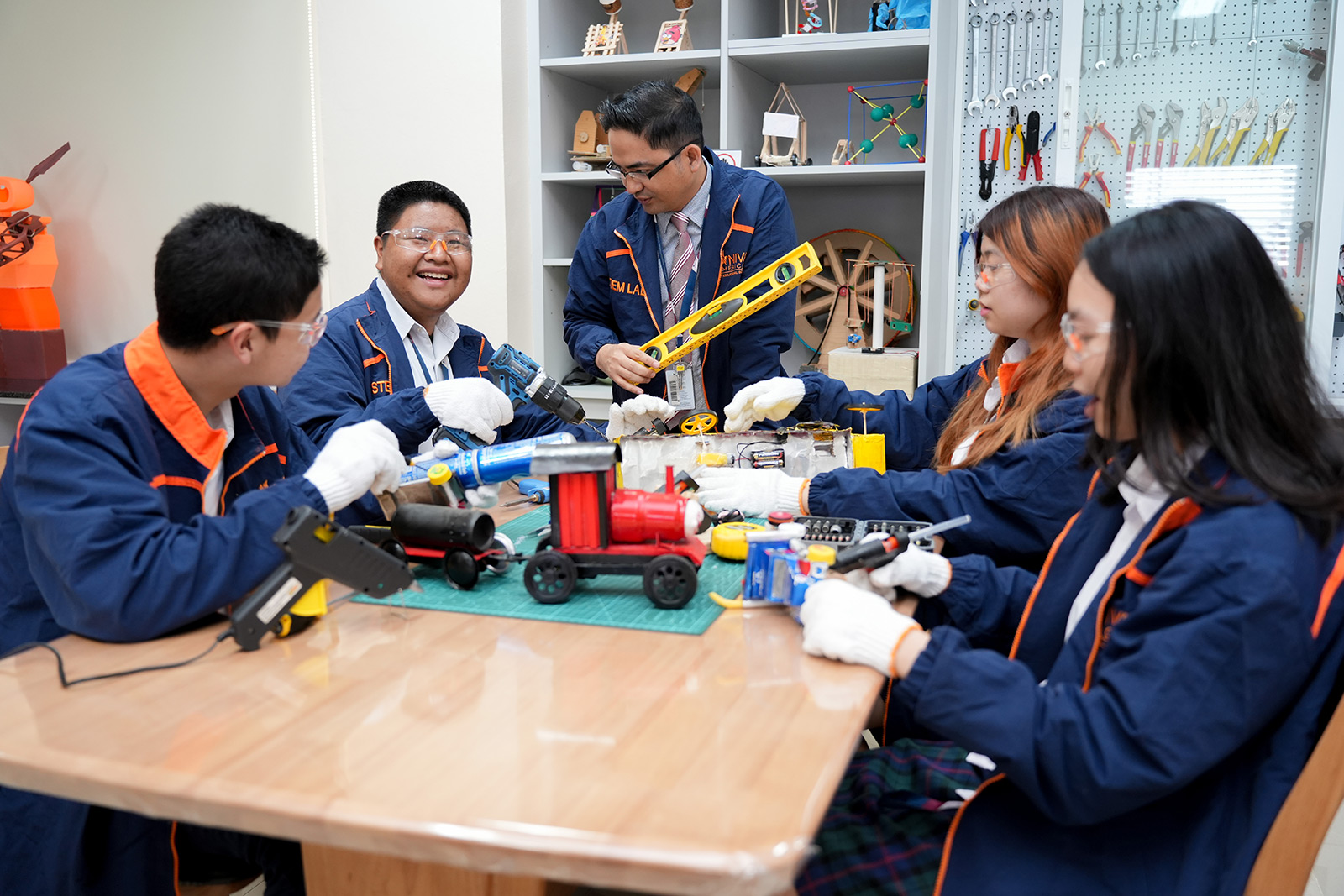 Students building a robot together in the STEM lab