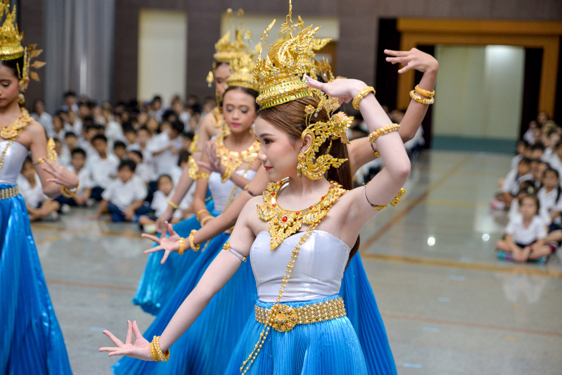 Students performing a Thai dance in traditional costumes